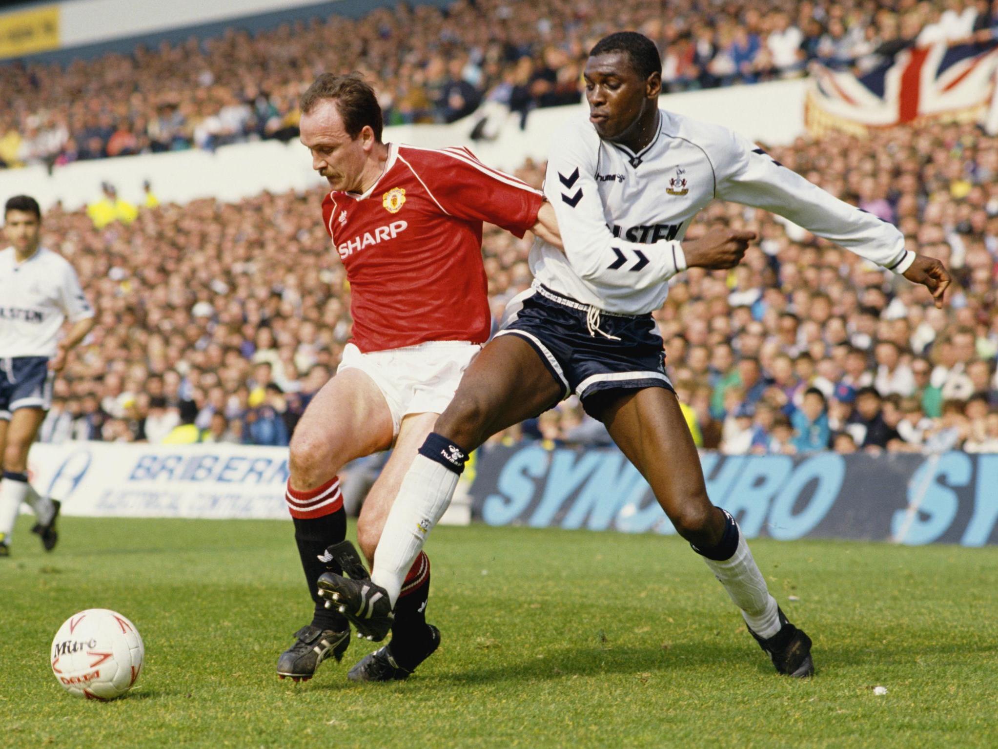 Mike Phelan is challenged by Tottenham's Mitchell Thomas