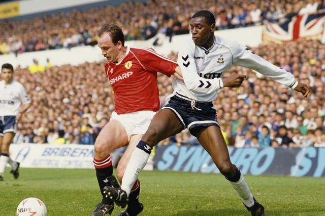 Mitchell Thomas of Spurs challenges Mike Phelan of Man United