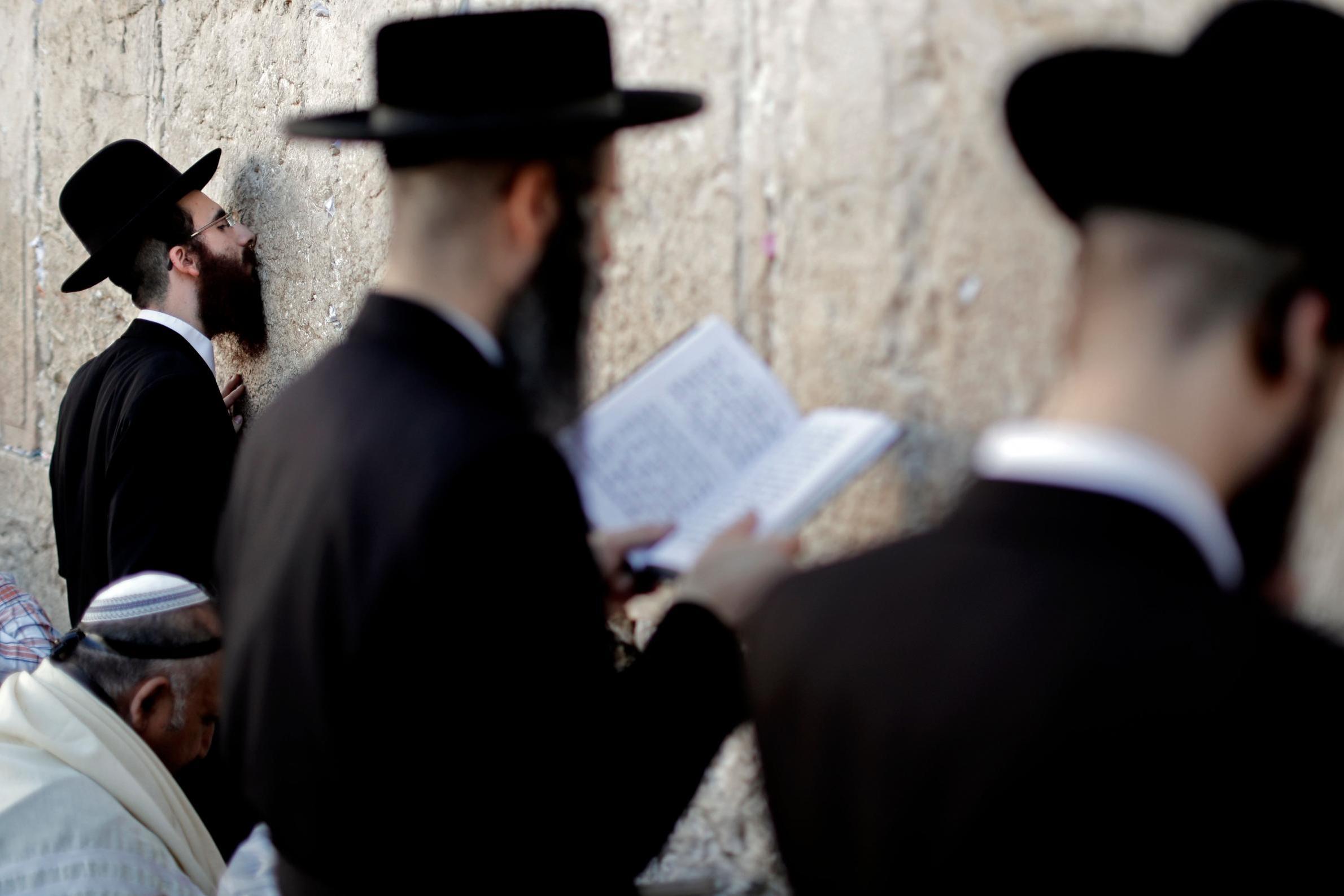 Ultra-Orthodox Jewish men pray at the Western Wall in the Old City of Jerusalem on the eve of Yom Kippur