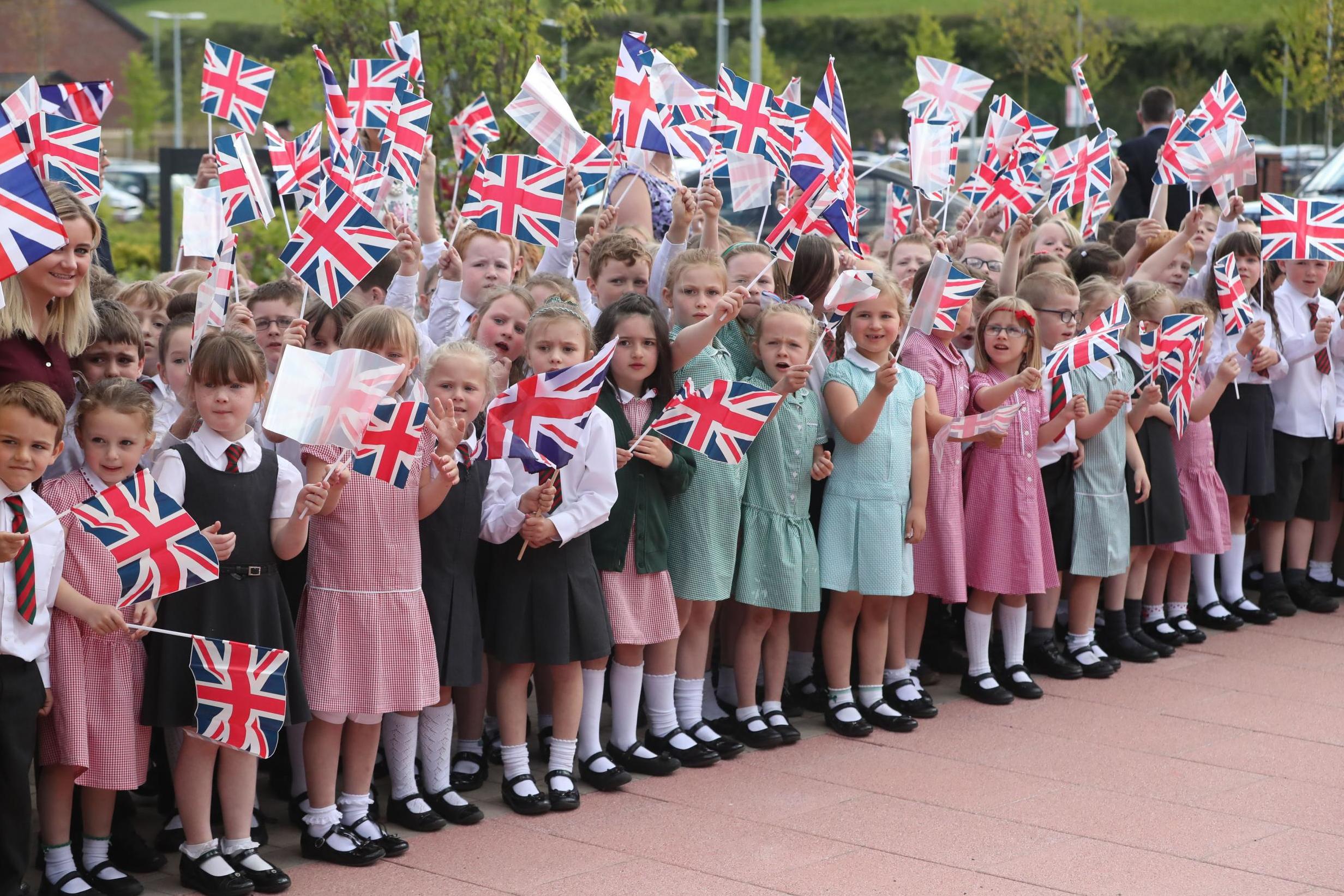 Schoolchildren wait for the arrival of the Duchess of Cornwall to Dromore Central Primary School in County Down during her visit to Northern Ireland in May 2017 (PA)