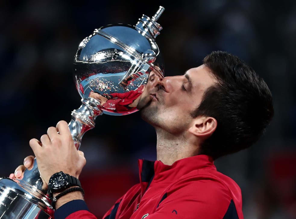 Novak Djokovic lifts the trophy after a dominant victory
