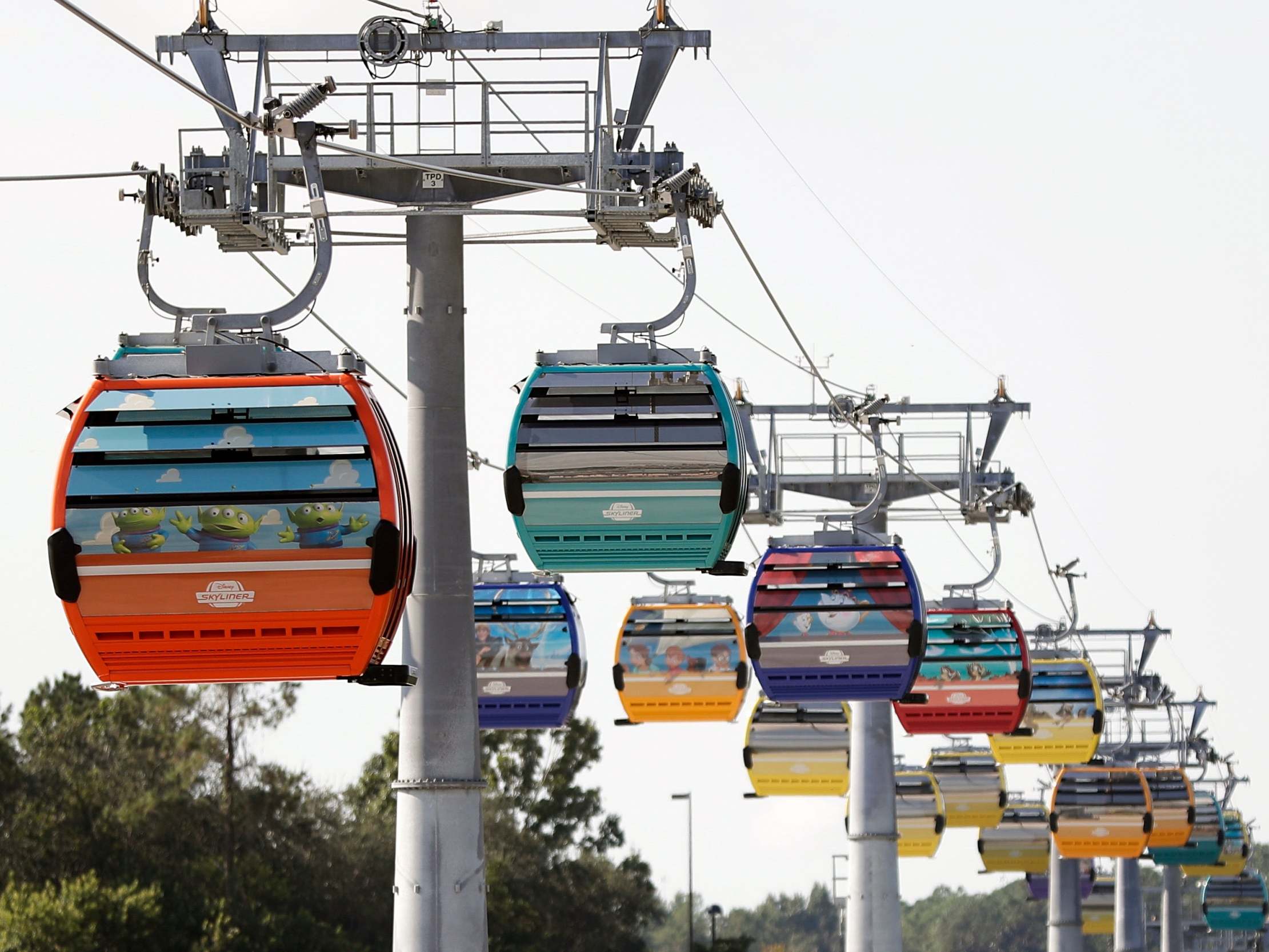 Firefighters have responded to help Walt Disney World holiday-goers who have been stuck aboard the Florida resort's newly launched aerial cable car system