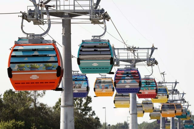 Firefighters have responded to help Walt Disney World holiday-goers who have been stuck aboard the Florida resort's newly launched aerial cable car system