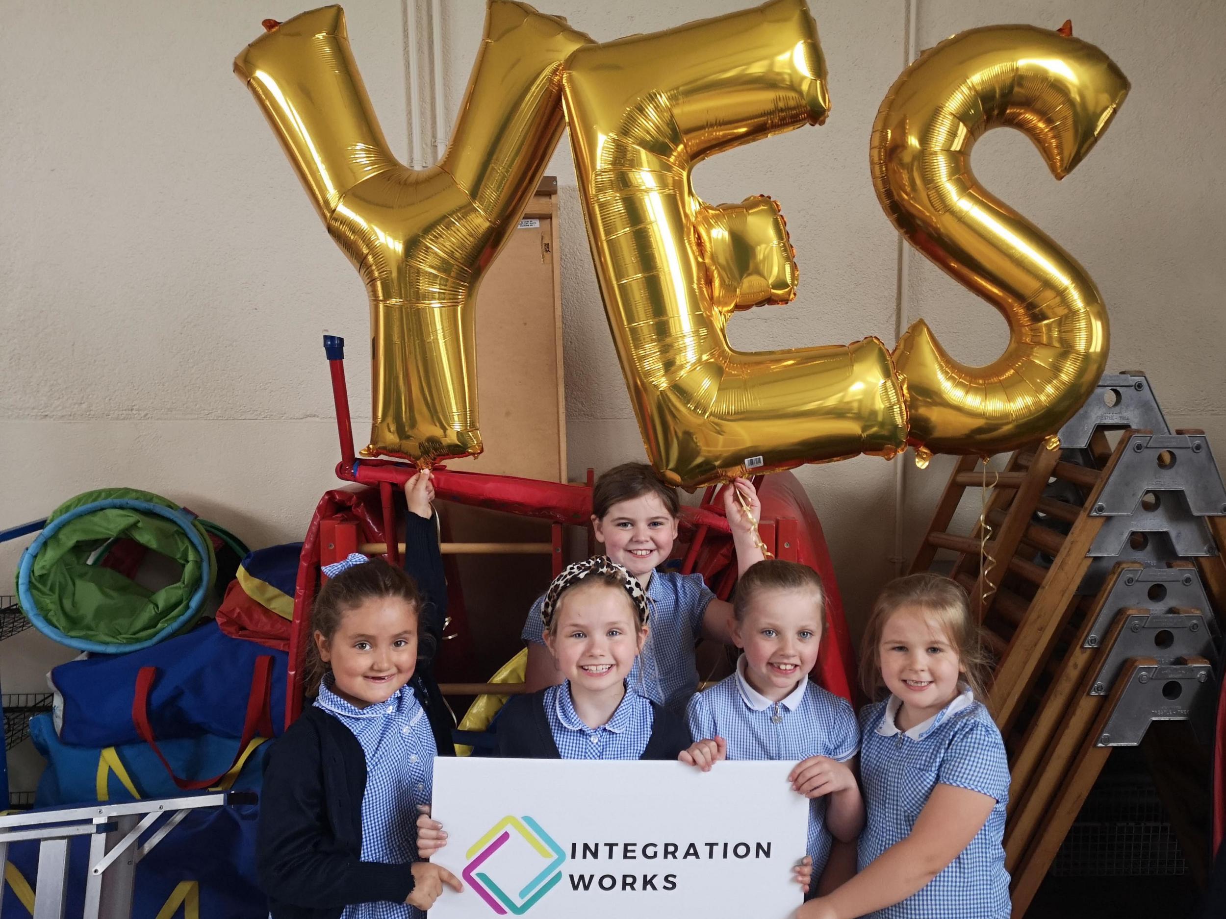 Pupils at Carrickfergus Central Primary School celebrating that their school voted overwhelmingly to take the school on the path to becoming officially integrated