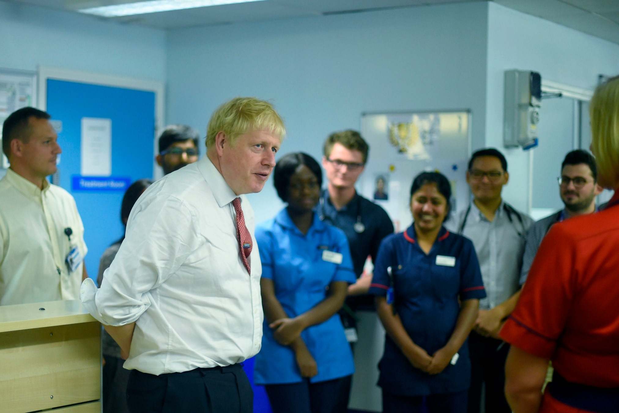 Boris Johnson speaks to medical staff during his visit to Watford General Hospital.