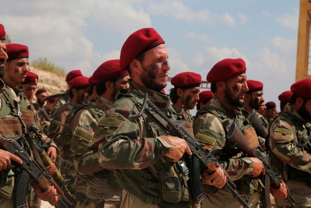 Turkish-backed forces from the Free Syrian Army, stand in formation during military maneuvers in preparation for an anticipated Turkish incursion targeting Syrian Kurdish fighters, near Azaz town