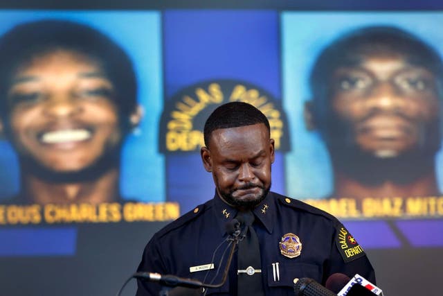 Dallas assistant police chief Avery Moore speaks at a press conference in front of images of suspects in Joshua Brown's killing
