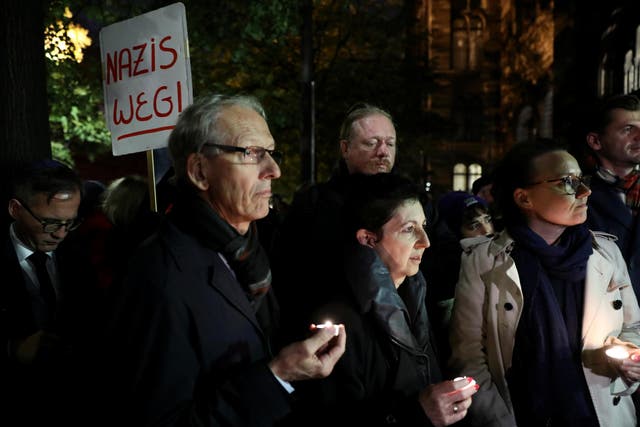 People attend a gathering at the New Synagogue in Berlin, Germany, October 9, 2019, after two people were killed in a shooting in the eastern German city of Halle.