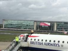 Man climbs on top of BA plane amid climate protests at London airport