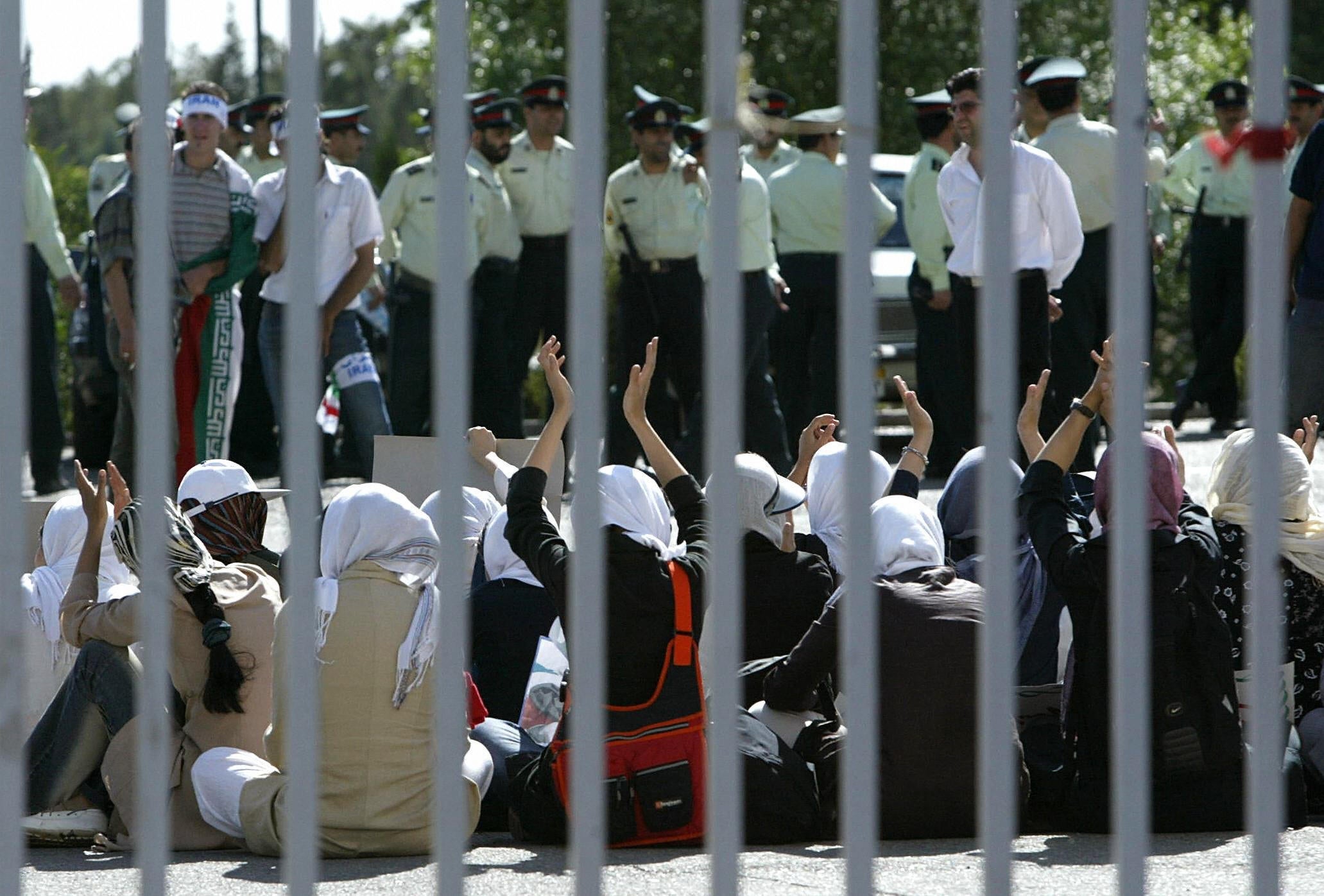 Female fans clap their hands while waiting to get into the stadium to watch the Iran v Bahrain 2006 World Cup qualifier