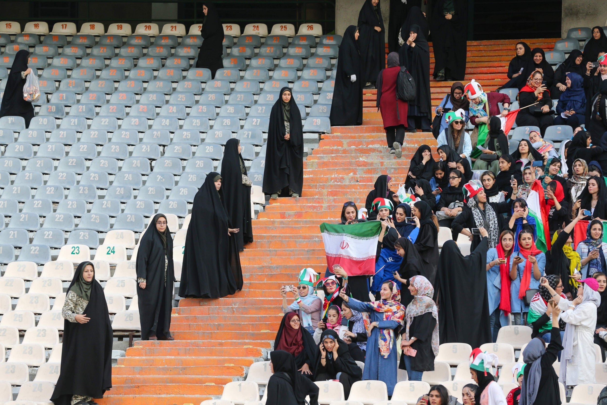 The women were fenced into a small part of the stadium, the rest of which was mostly empty