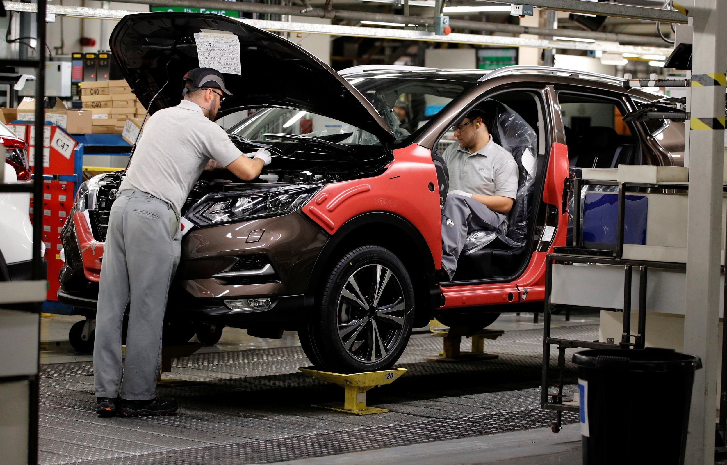 Workers are seen on the production line at Nissan's car plant in Sunderland