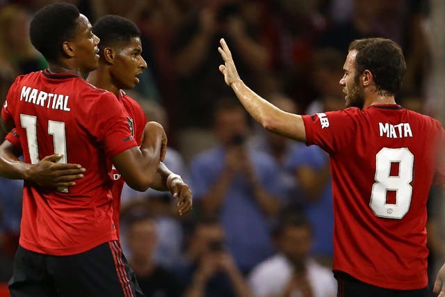 Manchester United's Marcus Rashford celebrates with Anthony Martial and Juan Mata
