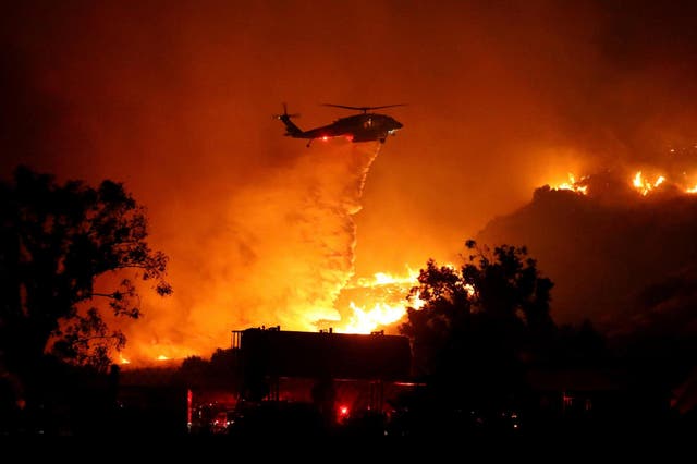 Water is dropped on a large brush fire in Sylmar, California