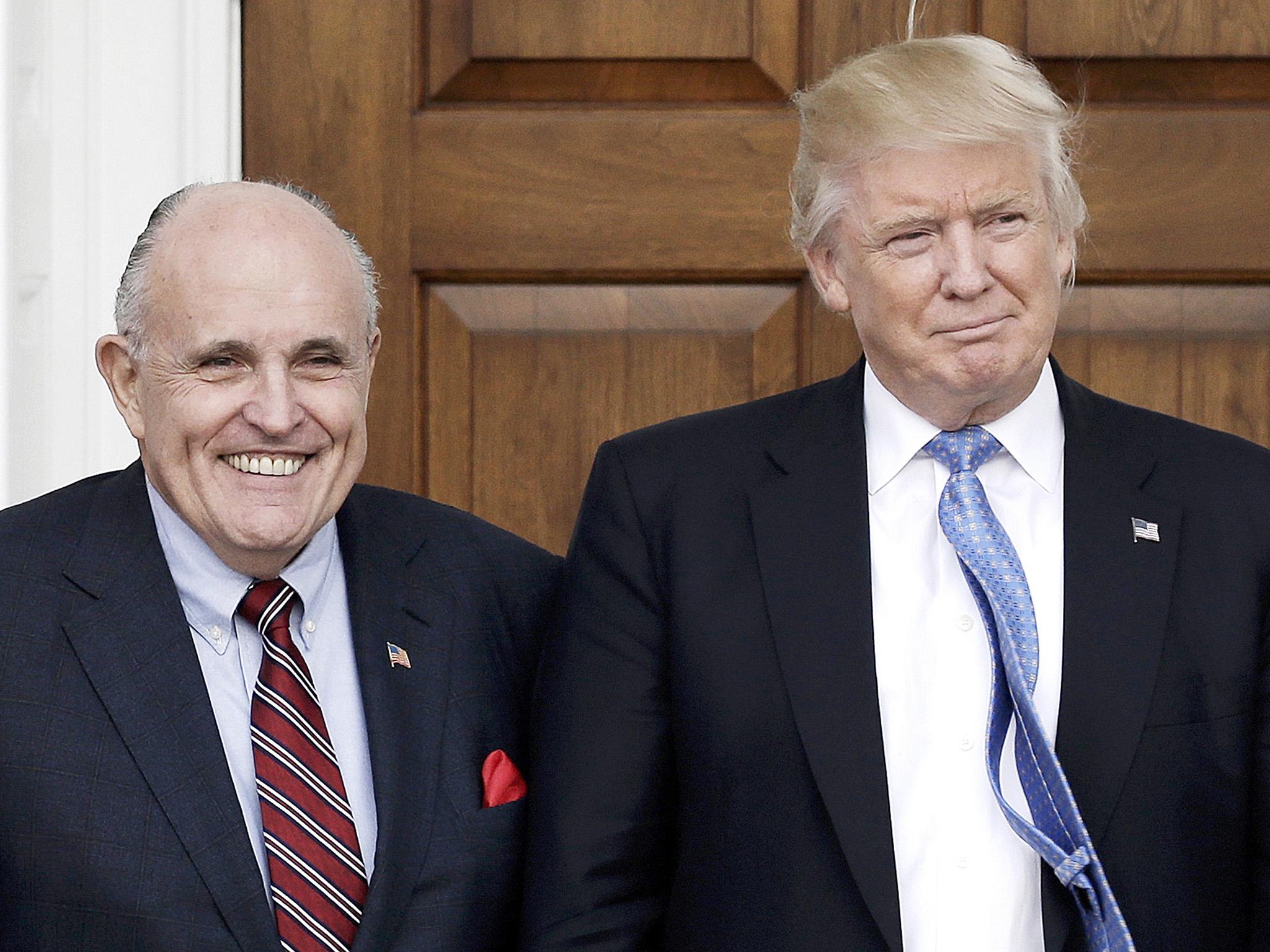 Former New York City Mayor Rudy Giuliani poses with President Trump at the clubhouse of Trump International Golf Club in New Jersey in 2016. EPA/PETER FOLEY