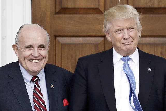 Former New York City Mayor Rudy Giuliani poses with President Trump at the clubhouse of Trump International Golf Club in New Jersey in 2016. EPA/PETER FOLEY