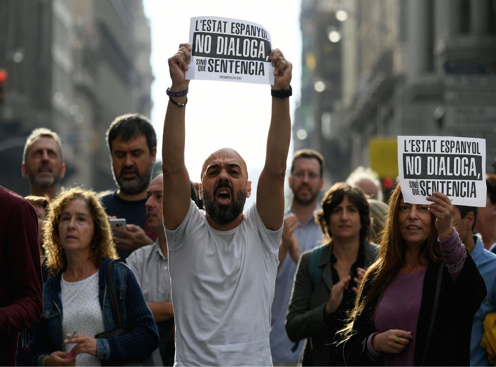 Protesters hold placards reading ‘the Spanish state does not talk, it sentences’, in Barcelona on Monday