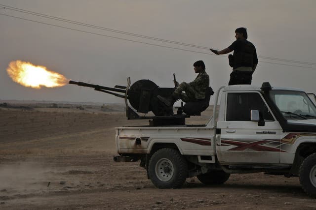 Turkish-backed Syrian fighters fire a truck mounted heavy gun near the town of Tukhar, north of Syria's northern city of Manbij, on Monday