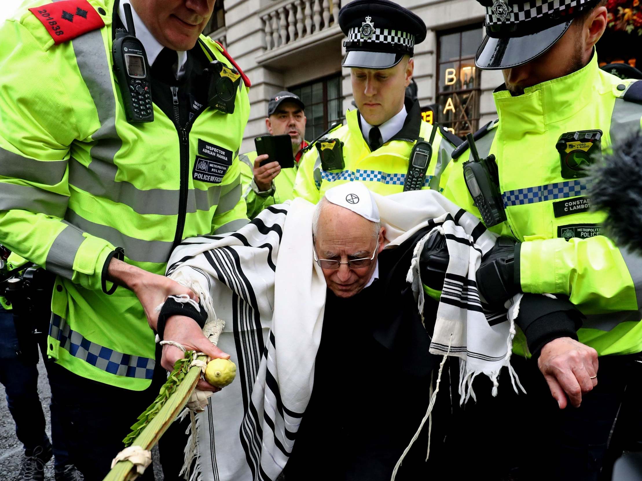 Rabbi Jeffrey Newman is arrested as protesters continue to block the road outside Mansion House in the City of London