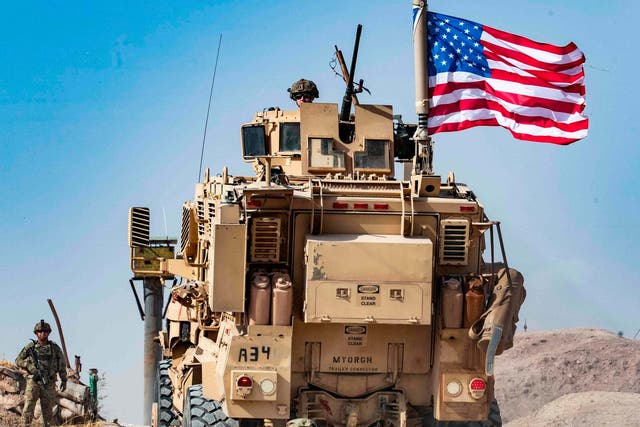A US soldier on an armoured vehicle in Syria's Hasakeh province close to the Turkish border