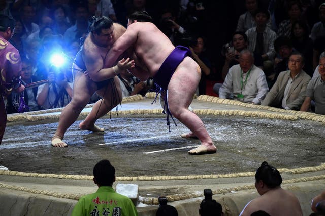 Sumo wrestlers in action during the Summer Grand Sumo Tournament in Tokyo last May