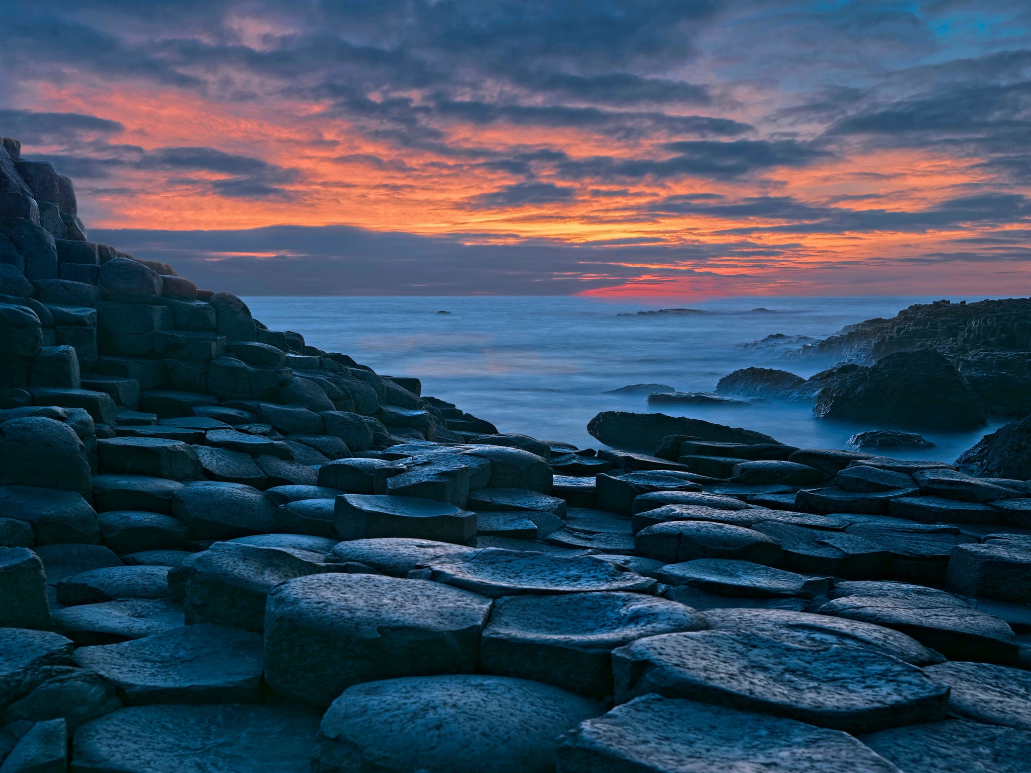 Basalt columns at dusk with majestic cloudscape at Giants Causeway, Northern Ireland