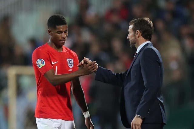 Marcus Rashford shakes hands with Gareth Southgate after the match (