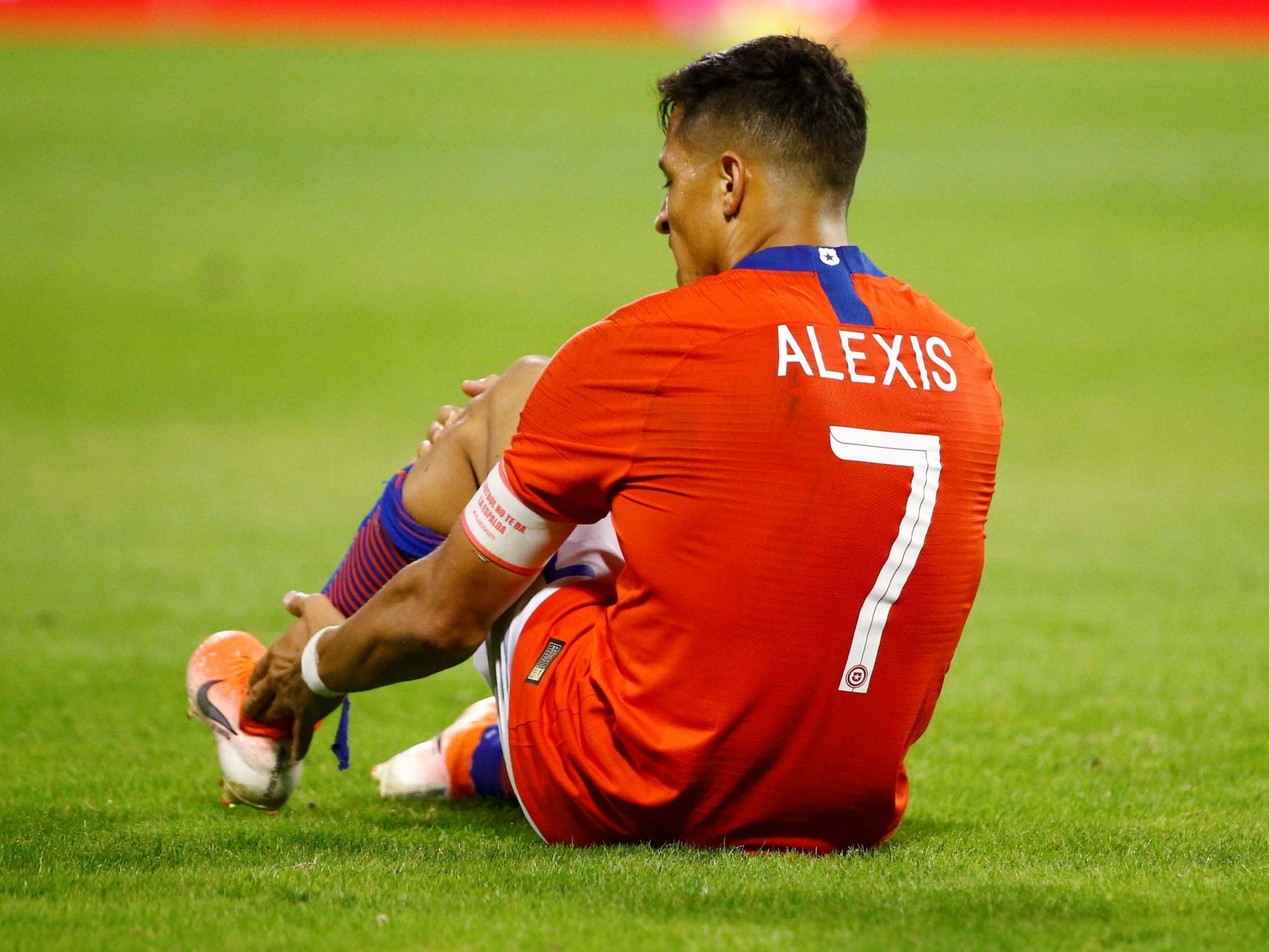 Chile's Alexis Sanchez reacts on the ground