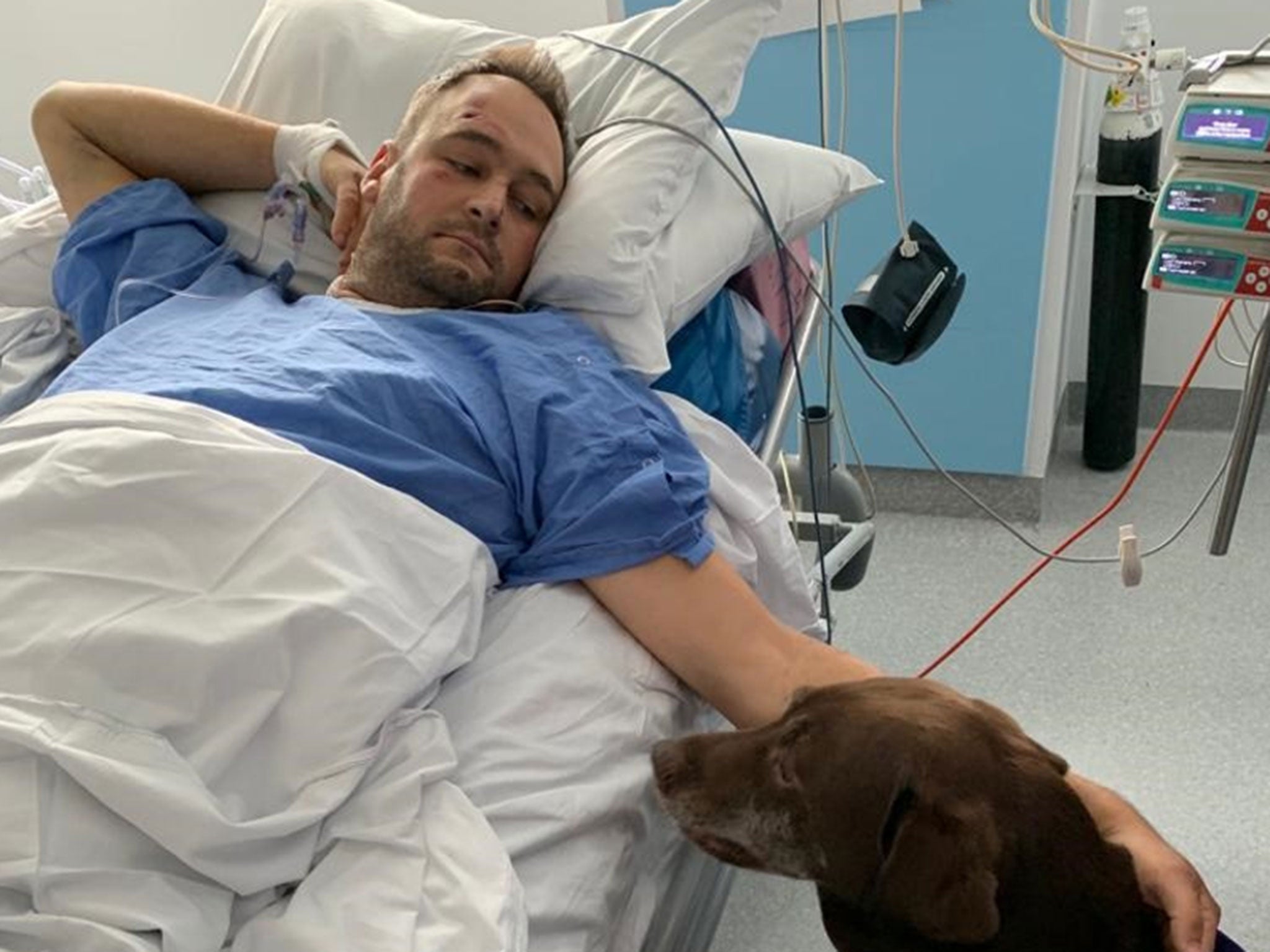 PC Gareth Phillips with his dog in hospital, where he underwent several rounds of surgery