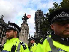 Extinction Rebellion protesters scale buildings and block roads