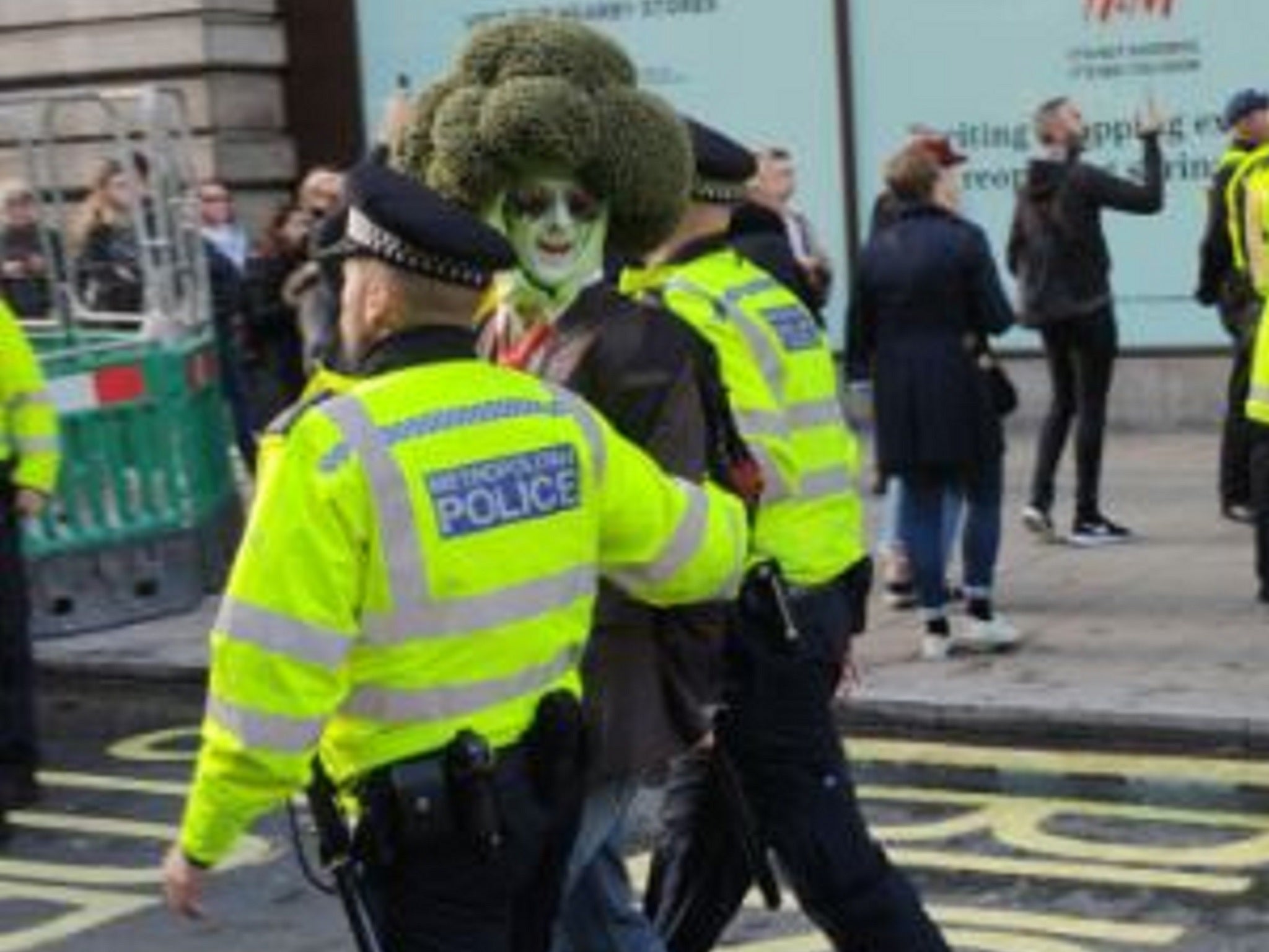 A man dressed as a broccoli is arrested during an Extinction Rebellion protest in Oxford Street, London, 14 October 2019.