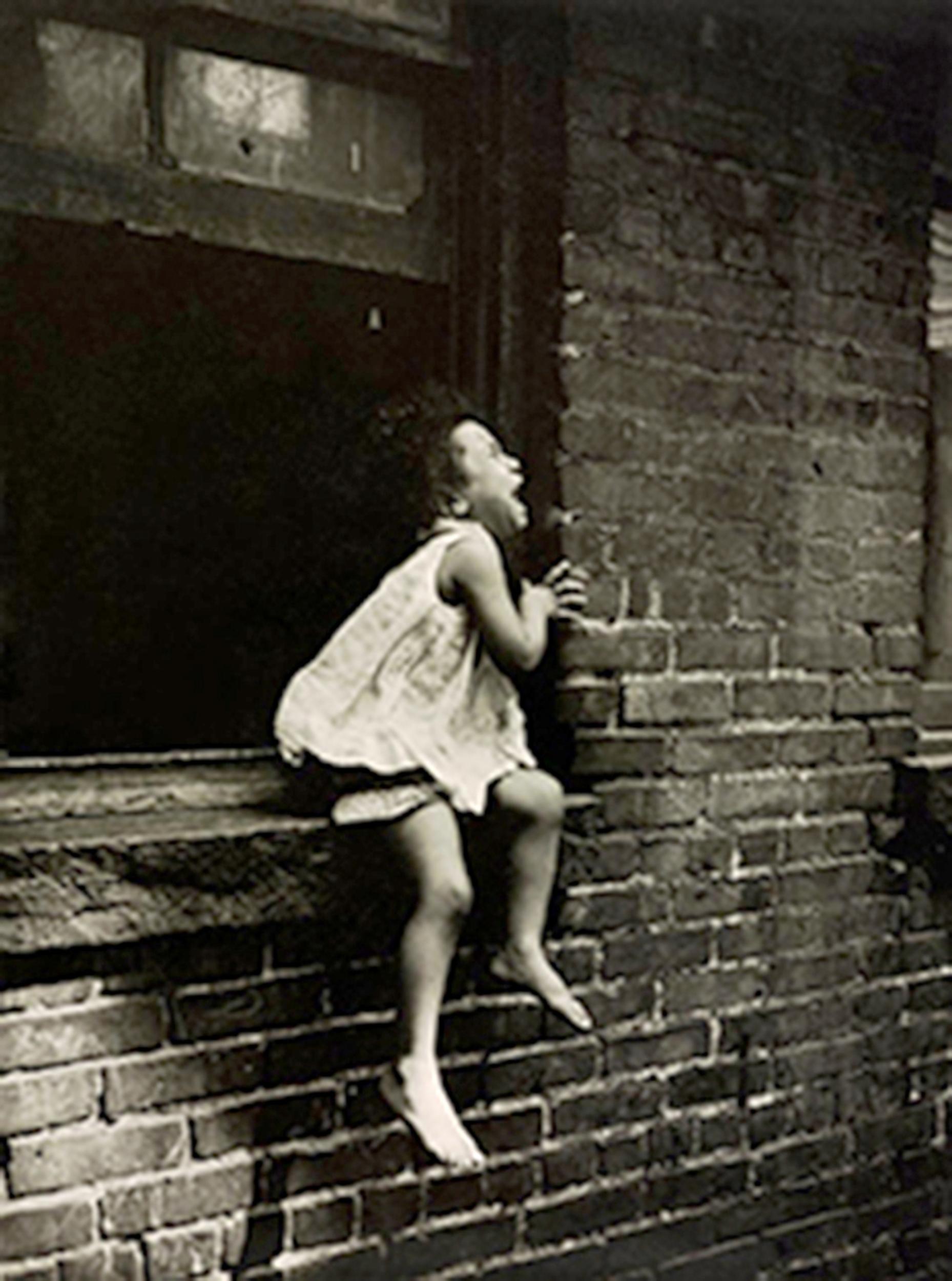 Child crying at a window in Manhattan, New York