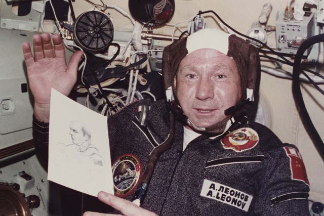 Leonov shows his drawing of Apollo commander Thomas P Stafford during a mission in July 1975