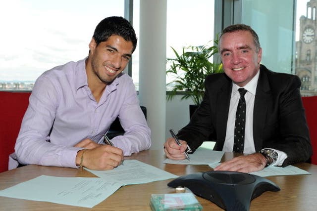 Luis Suarez signs a new Liverpool contract with Managing Director Ian Ayre in 2012