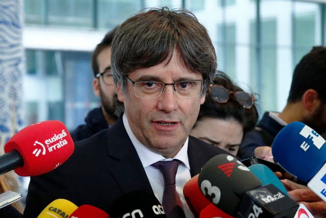 Carles Puigdemont leaves a prosecutor office at the Justice Palace after handing himself in to police in Brussels