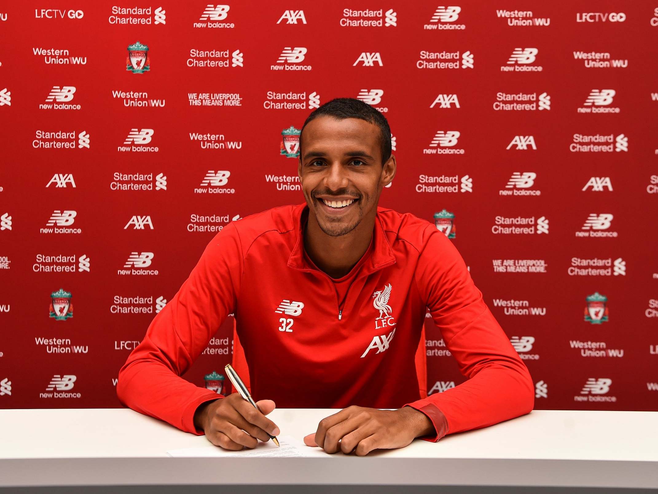 Joel Matip of Liverpool signing a contract extension