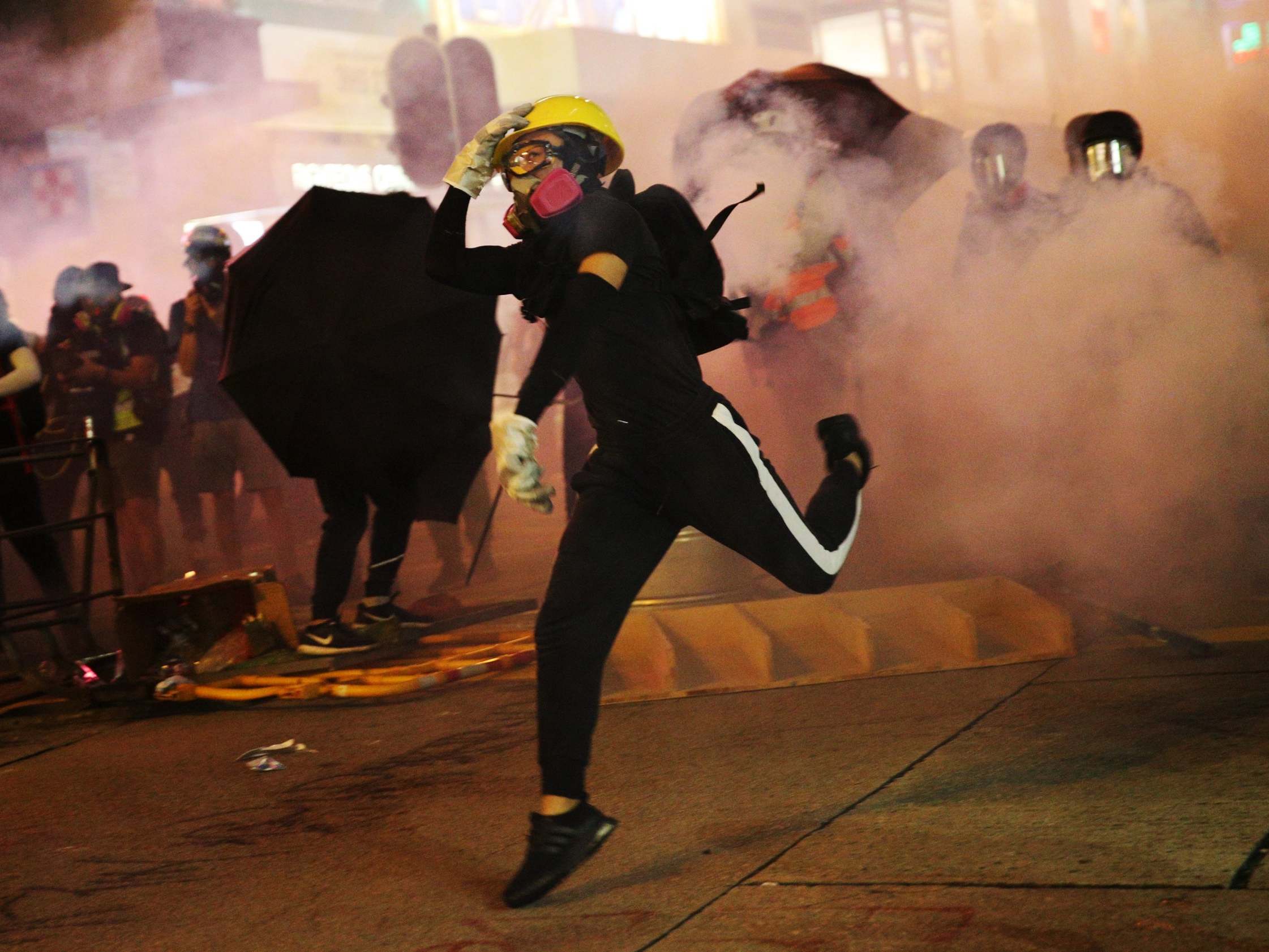 Hong Kong activist stabbed as thousands of protesters clash with police officers during chaotic march