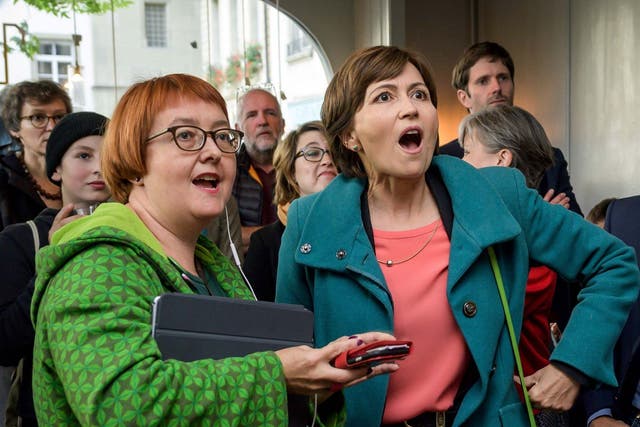 Green Party leader Regula Rytz (right) takes in the announcement of the first election results in Bern