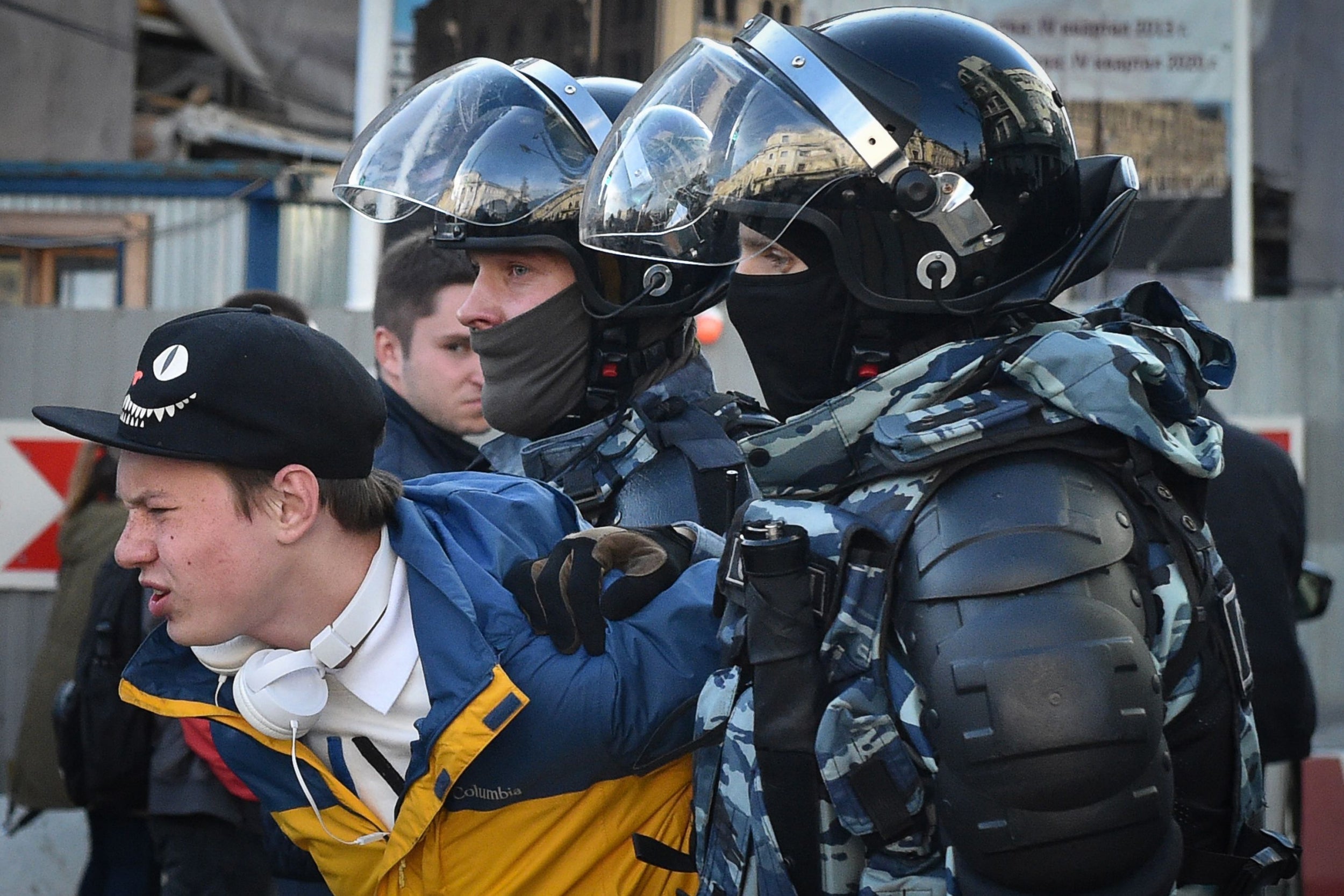Police officers detain a man after a rally urging fair elections in Moscow in August