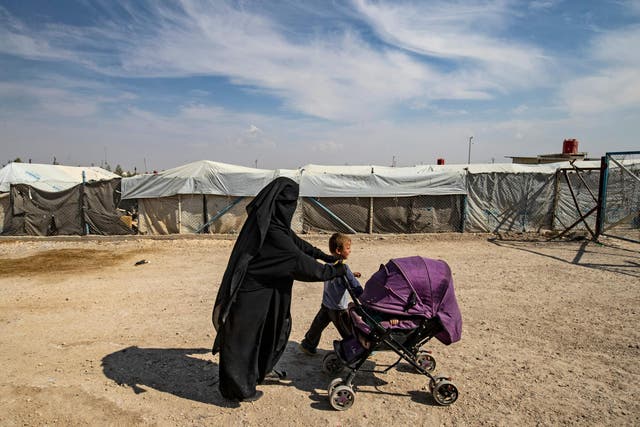 A woman accompanies children at the Kurdish-run al-Hol camp for the displaced where families of Isis foreign fighters are held