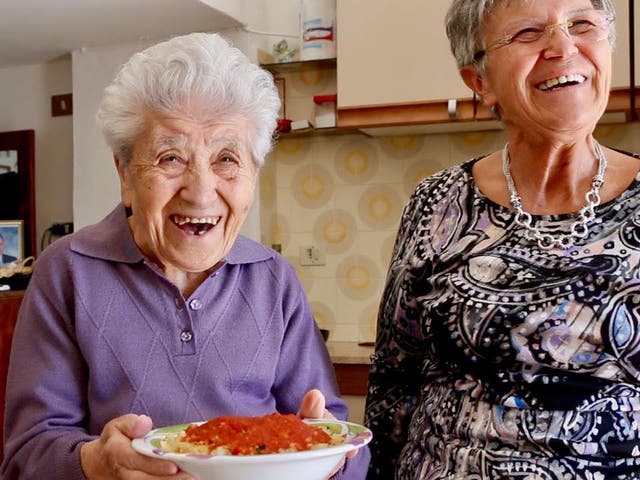 Rachele, 95, holds a local favourite, maccheroni a descita, made with daughter Domenica's help 