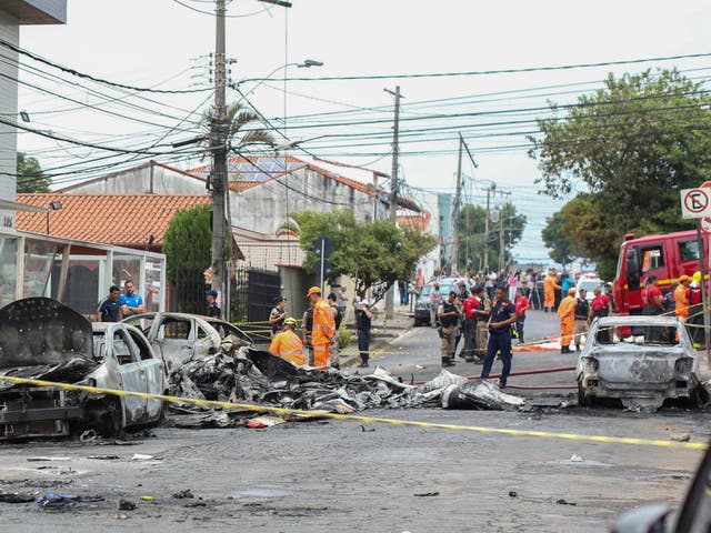 Wrecked cars are seen at the site where a small plane crashed on a residential street in Belo Horizonte, Brazil