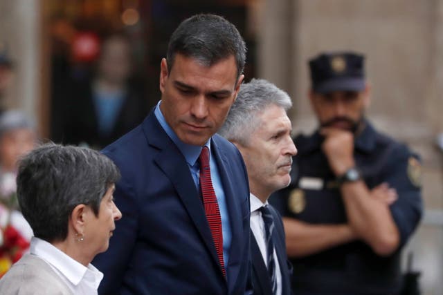 Spain's acting Prime Minister Pedro Sanchez and Spain's acting Interior Minister Fernando Grande-Marlaska leave the National Police headquarters after a visit, in Barcelona, Spain, October 21, 2019.