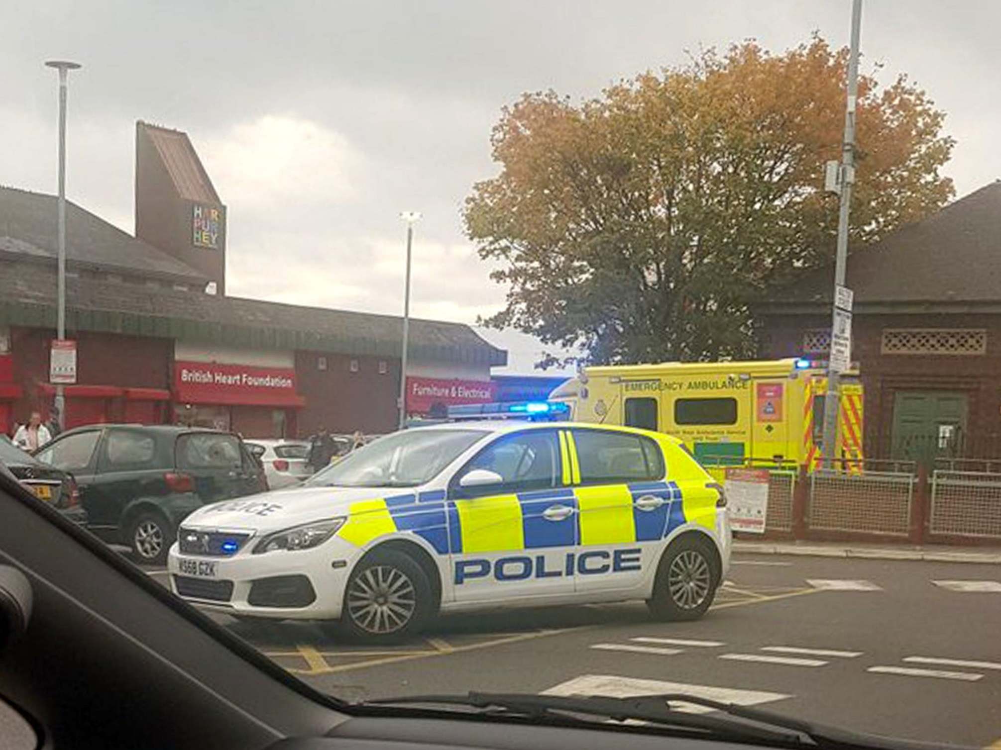 Police at the scene in Harpurhey, Manchester, after responding to reports of a stabbing at a McDonald's branch.