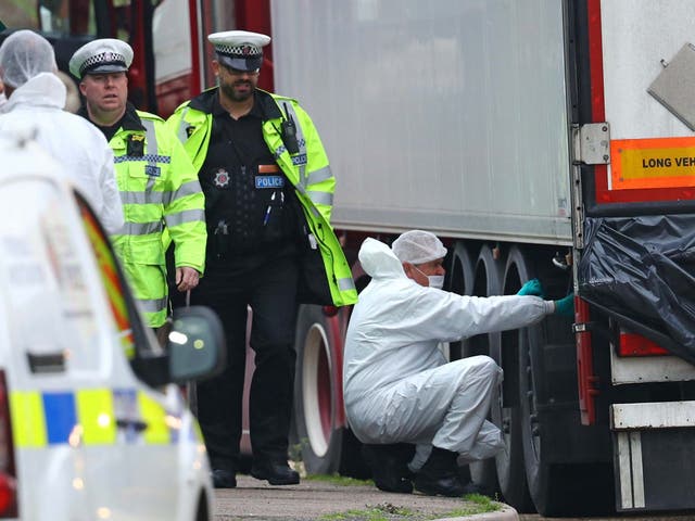 Forensics officers hunt for evidence on the lorry at the industrial park in Grays, Essex