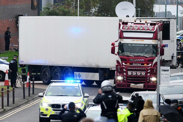 The HGV in which the bodies were discovered is driven away by police on Wednesday evening