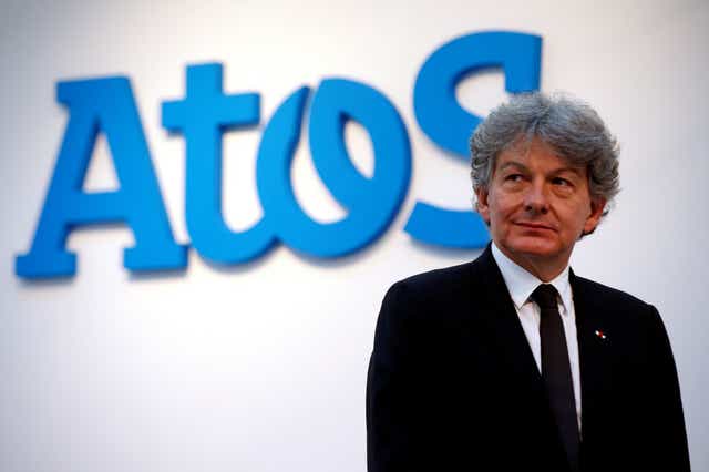 Atos Chairman and CEO Thierry Breton poses in front of the company's logo