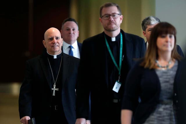 Samuel Aquila, archbishop of the Denver diocese of the Roman Catholic Church, left, trails Very Rev. Randy Dollins, vicar general, into a news conference at which a plan was revealed to have a former prosecutor review their diocese's sexual abuse files