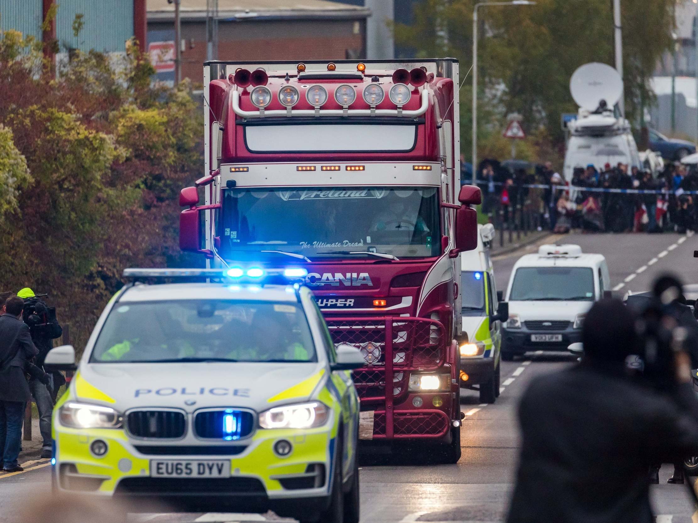 Police escort the lorry in which 39 bodies were discovered along the road from the scene in Waterglade Industrial Park, Grays, Essex