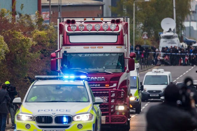 Police escort the lorry in which 39 bodies were discovered along the road from the scene in Waterglade Industrial Park, Grays, Essex